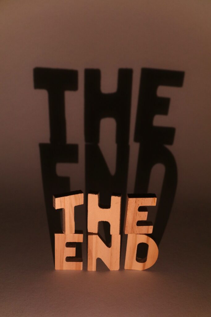 Creative shadow art using "The End" sculpture, playing with light and shadow effects.