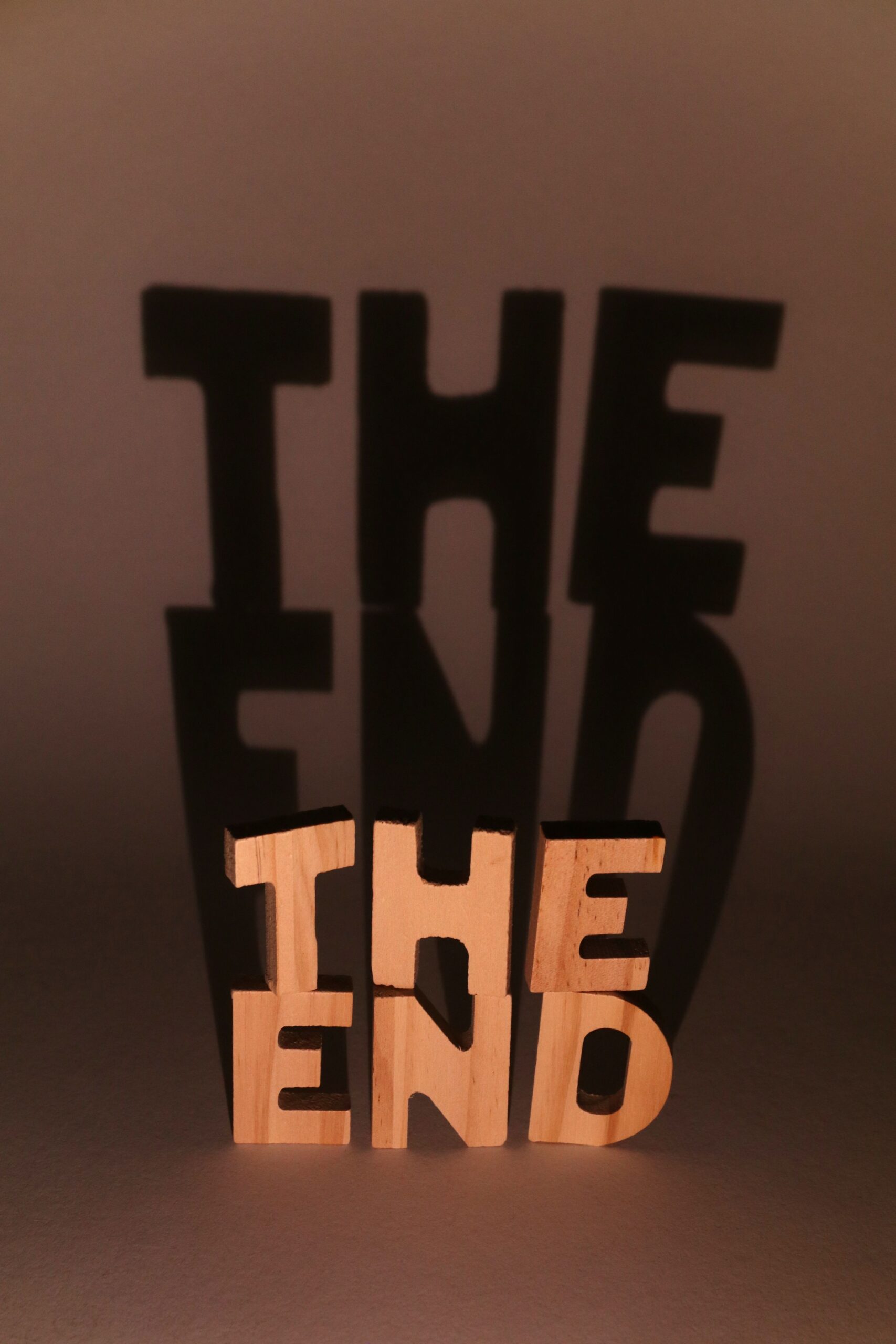 Creative shadow art using "The End" sculpture, playing with light and shadow effects.