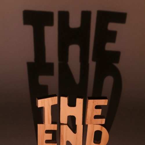 Creative shadow art using "The End" sculpture, playing with light and shadow effects.