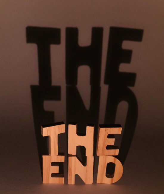 Creative shadow art using "The End" sculpture, playing with light and shadow effects.
