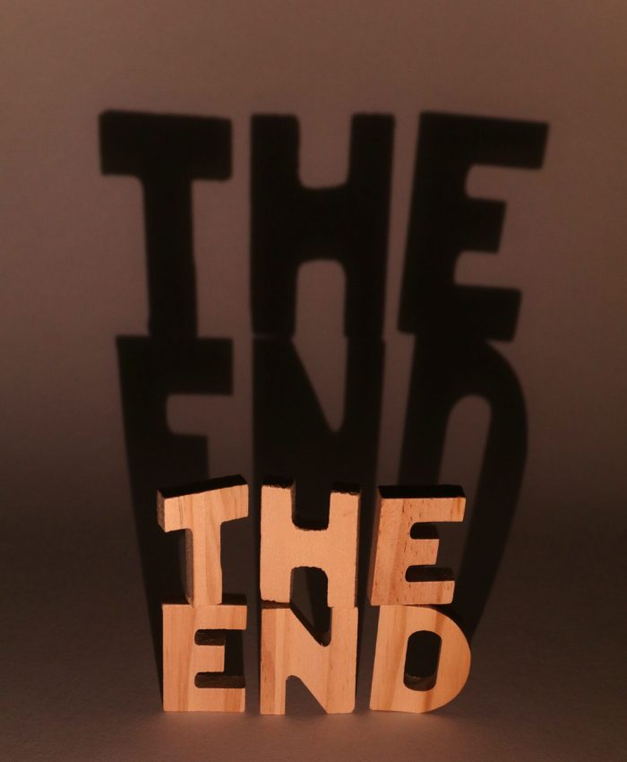 Creative shadow art using "The End" sculpture, playing with light and shadow effects.